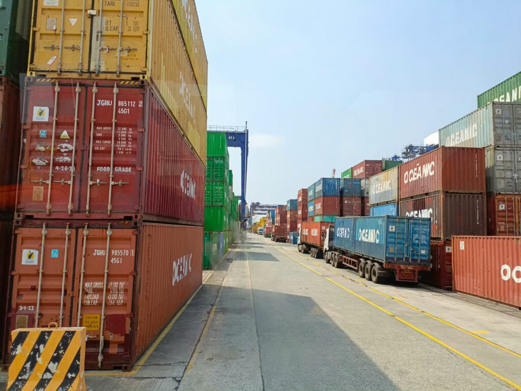 20ft and 40ft shipping containers stacked at a port terminal