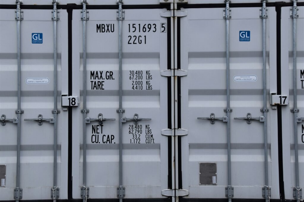 Wooden pallets loaded inside a shipping container with boxes